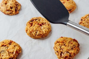 Squashing cookie with a spatula.