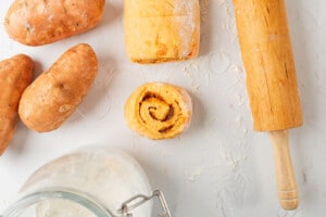 Cutting cinnamon roll dough with floss.