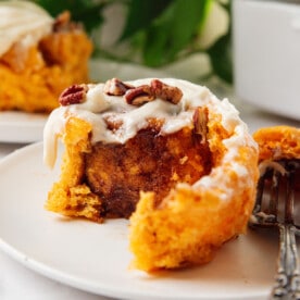 Unravelling a sweet potato cinnamon roll.