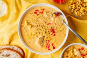 Vegan corn chowder in a bowl with a spoon.