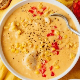 Vegan corn chowder in a bowl with a spoon.