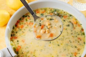 Avgolemono soup in a ladle.