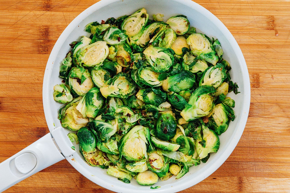 Cooking brussels sprouts in a pan.