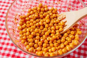 Mixing chickpeas with hot honey.