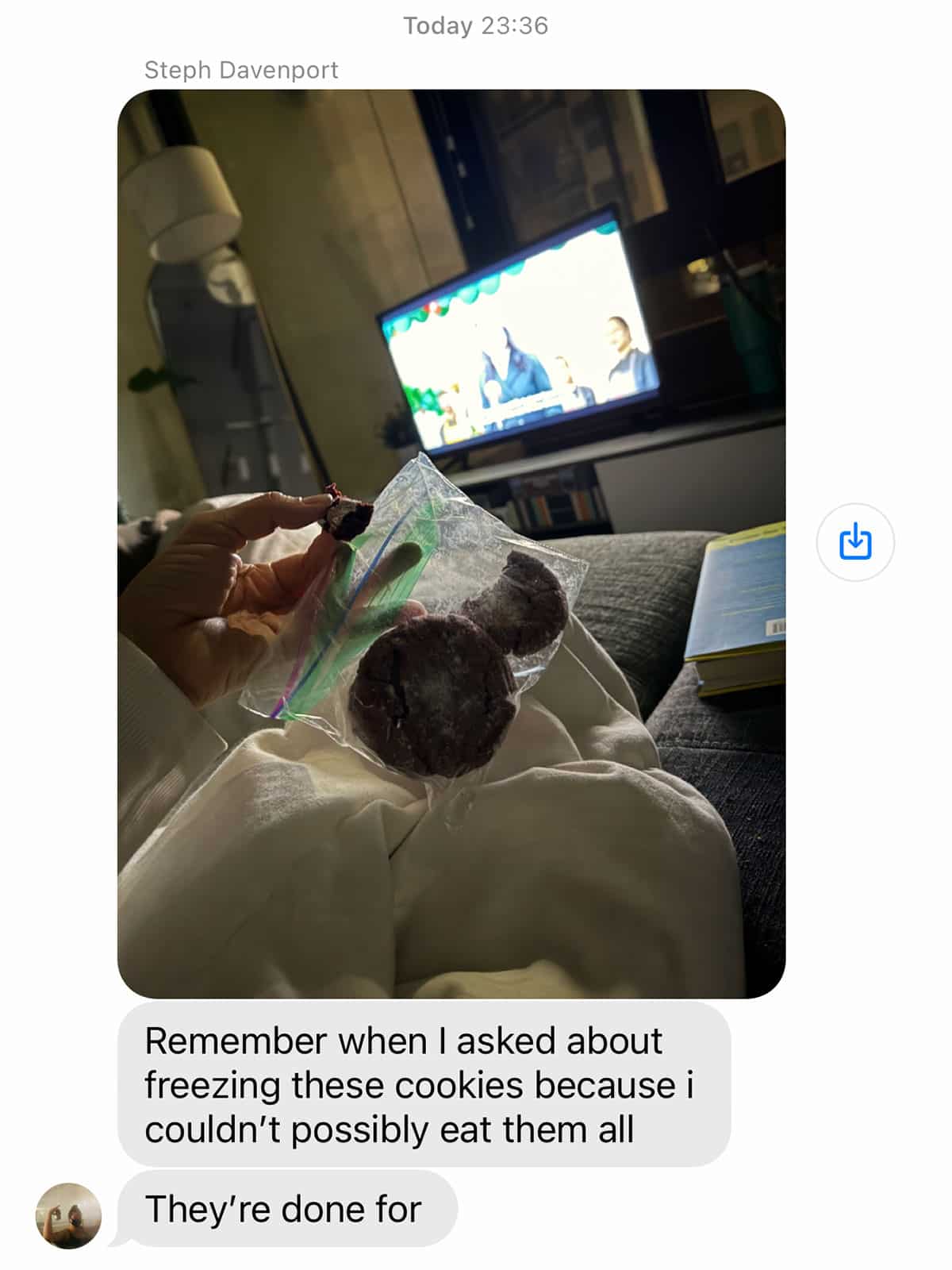 A person holds a plastic bag with vegan red velvet crinkle cookies while sitting on a couch; a TV is on in the background, and text messages discuss freezing cookies.