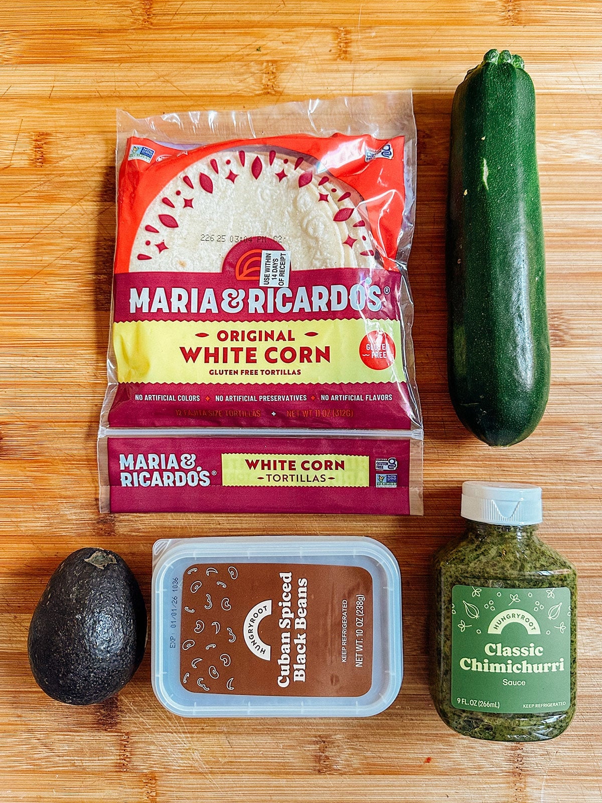 A package of white corn tortillas, a zucchini, an avocado, Cuban spiced black beans, and chimichurri sauceโperfect for quick vegetarian dinners or anyone seeking easy dinners inspired by this Hungryroot review.