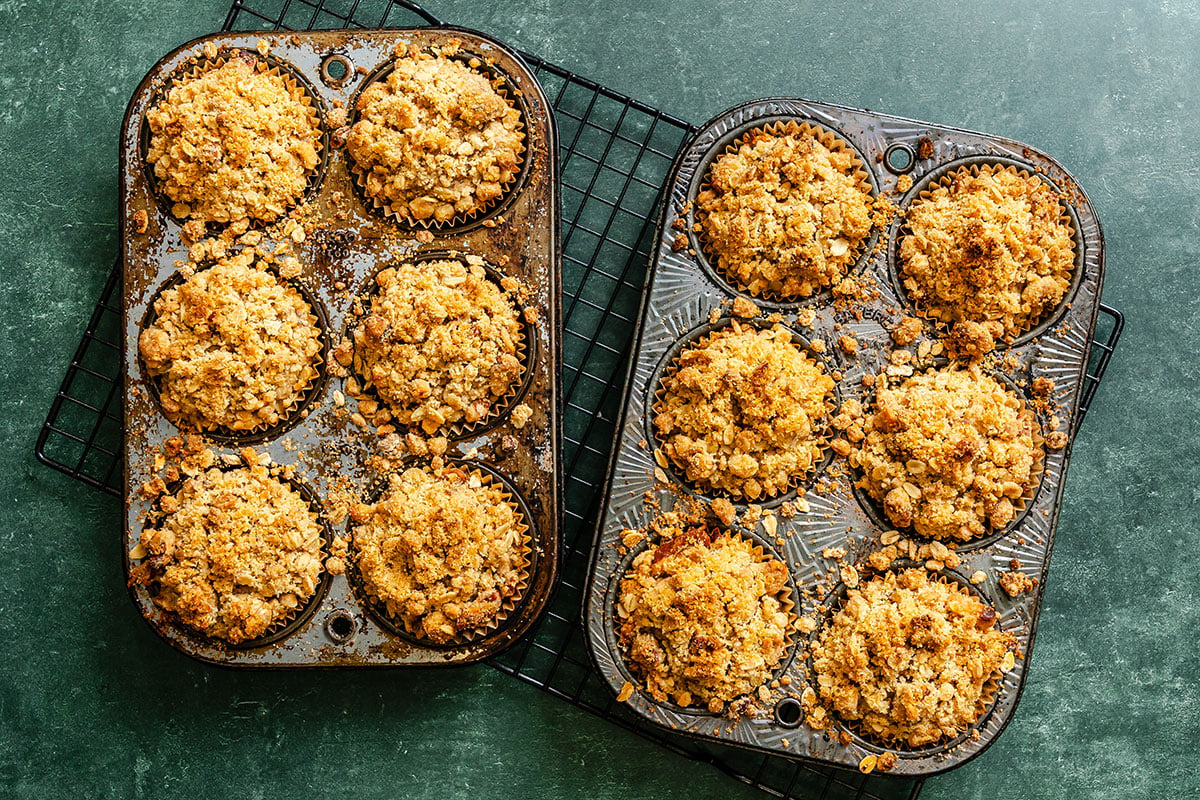 A couple of muffin tins on a cooling rack.