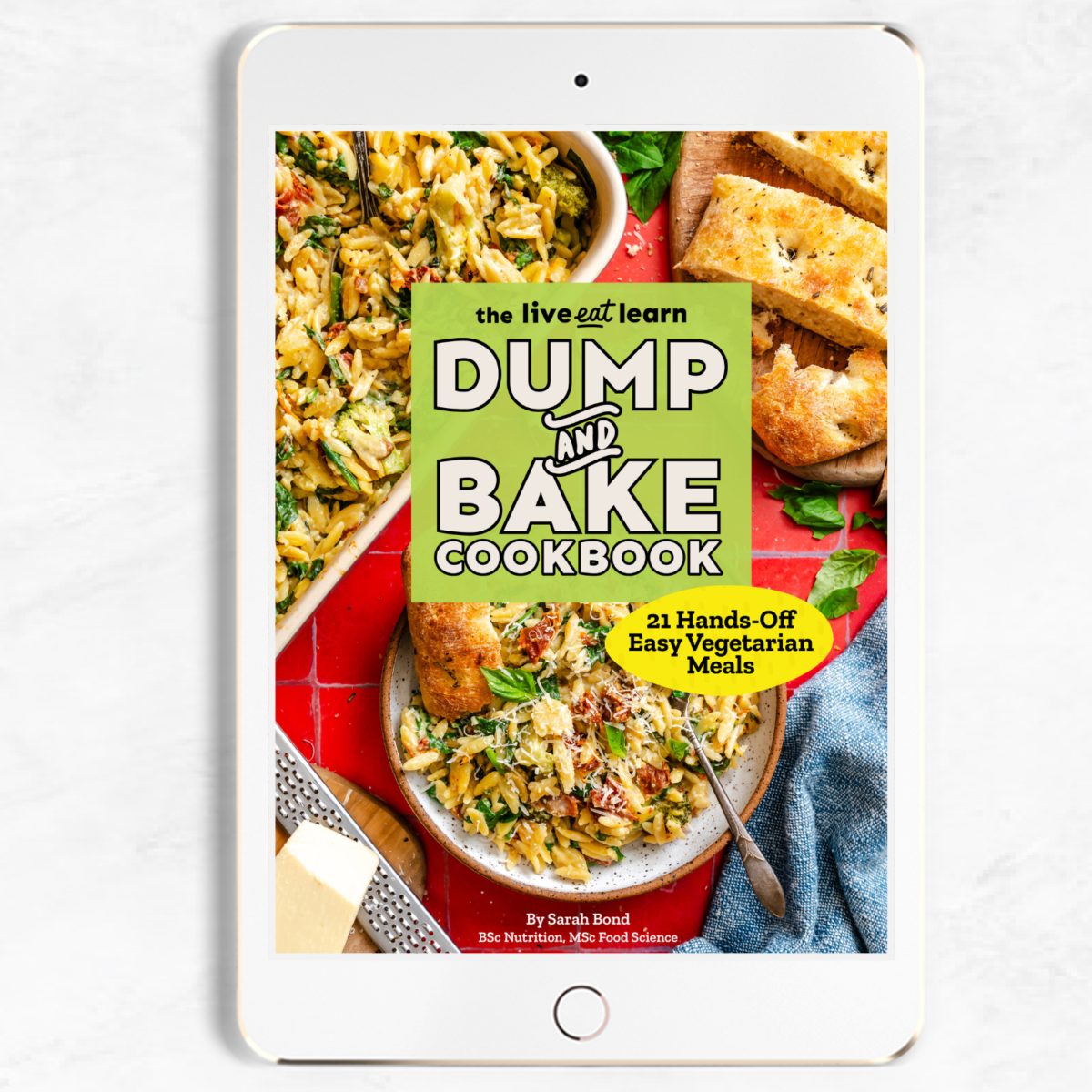 An iPad displaying the cover of Dump and Bake Cookbook featuring a casserole dish, slices of bread, and a serving spatula on a red background—perfect inspiration for anyone who loves dump and bake meals or is searching for easy oven recipes.